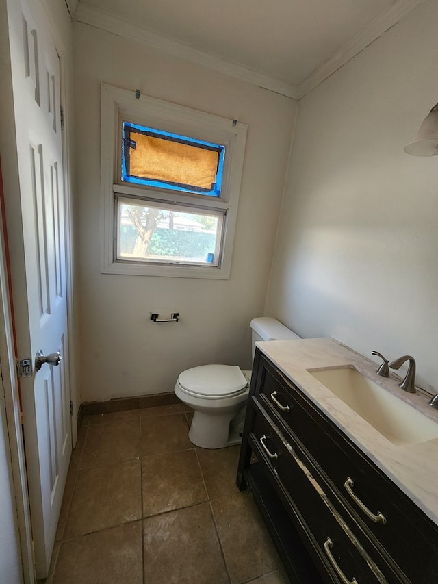 bathroom with tile patterned floors, vanity, toilet, and ornamental molding