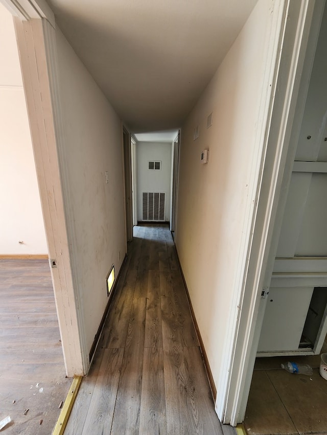 corridor featuring dark hardwood / wood-style flooring