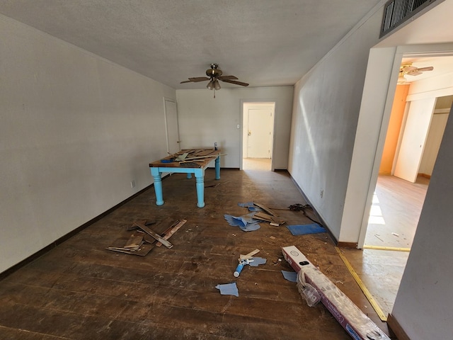 empty room with ceiling fan, a textured ceiling, and hardwood / wood-style flooring