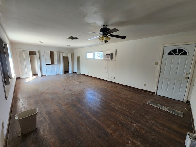 unfurnished living room with a wall mounted AC, dark hardwood / wood-style floors, and ceiling fan