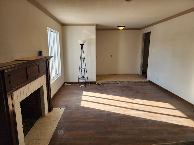 unfurnished living room featuring dark hardwood / wood-style flooring, a brick fireplace, and crown molding