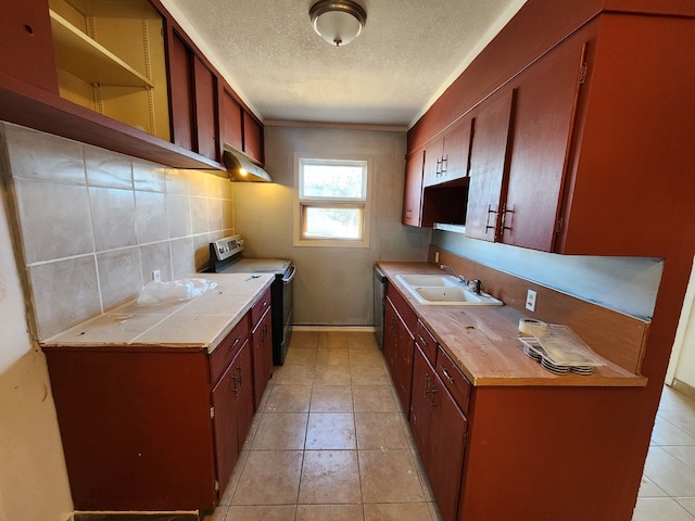 kitchen with light tile patterned flooring, backsplash, stainless steel appliances, and sink