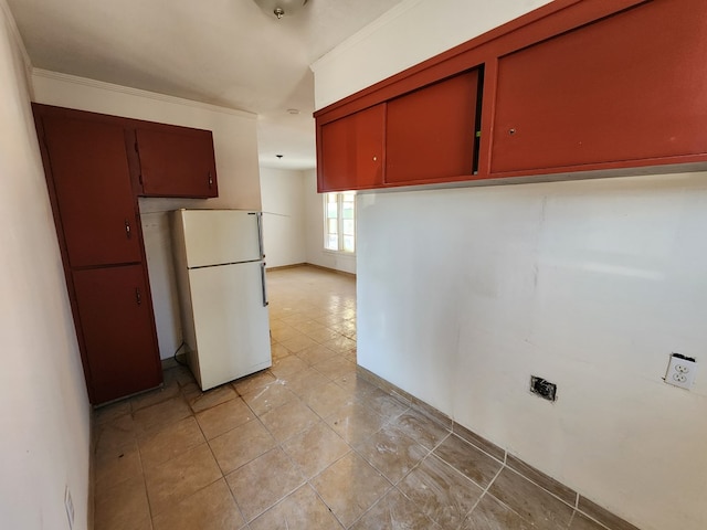 kitchen featuring white refrigerator and ornamental molding