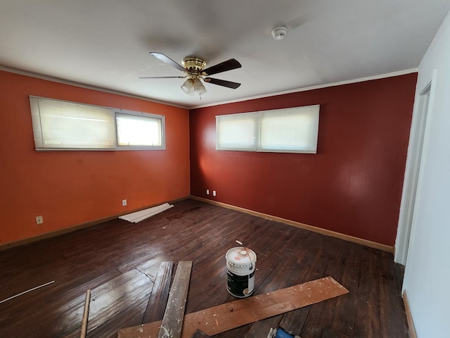 spare room with ornamental molding, ceiling fan, and dark wood-type flooring