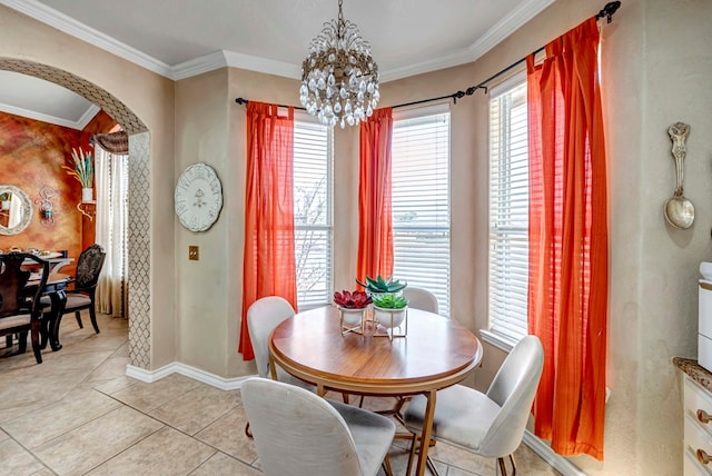 dining space featuring light tile patterned flooring, arched walkways, a chandelier, and crown molding