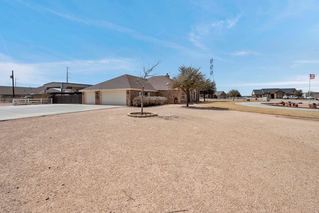 ranch-style home with brick siding, concrete driveway, fence, and a garage