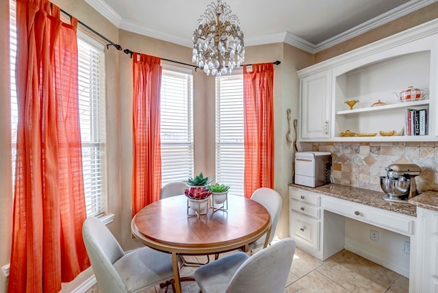 dining room with light tile patterned floors, a notable chandelier, ornamental molding, and built in desk