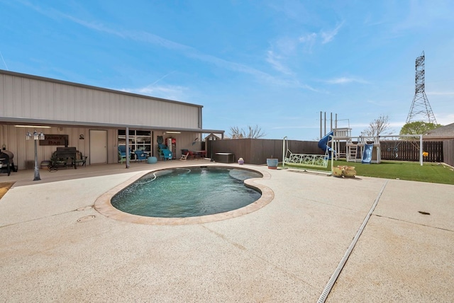 view of swimming pool with a patio, a playground, a fenced backyard, and a fenced in pool