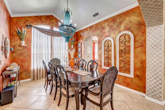 dining space featuring a notable chandelier, lofted ceiling, crown molding, light tile patterned floors, and baseboards