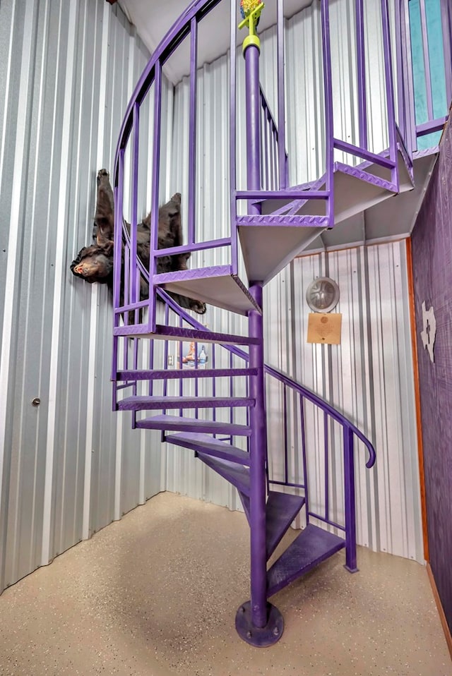 staircase featuring speckled floor