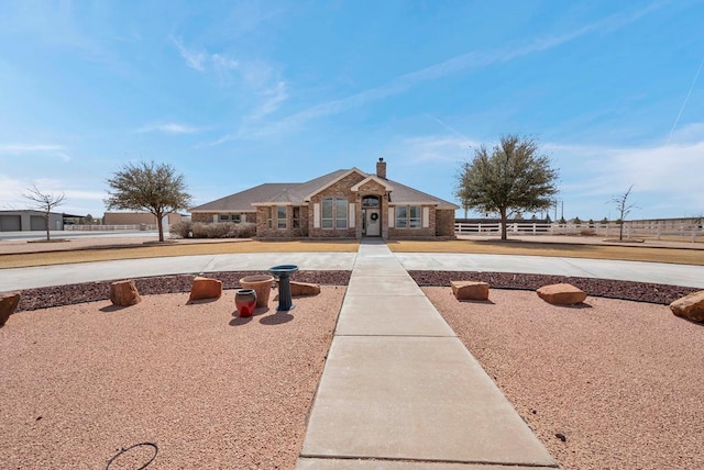 view of front of home featuring a chimney and fence