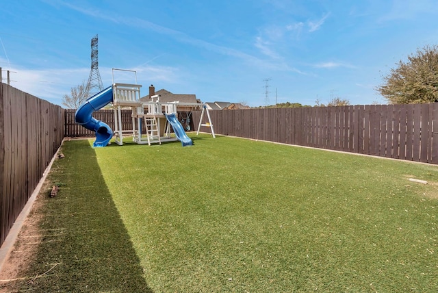 view of yard with a playground and a fenced backyard