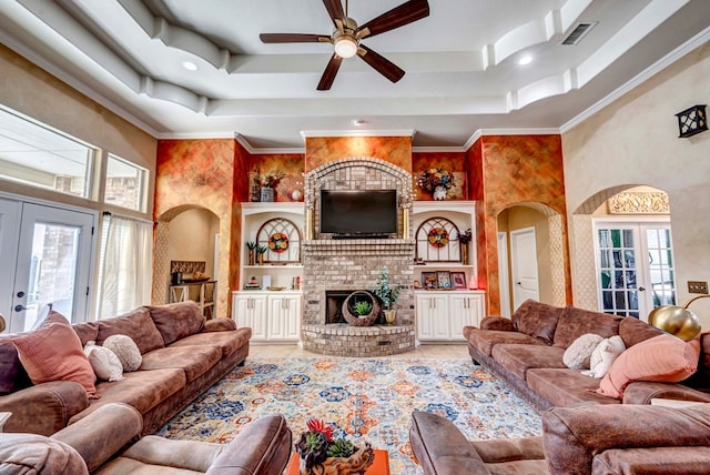 living room with visible vents, french doors, a fireplace, a raised ceiling, and ceiling fan