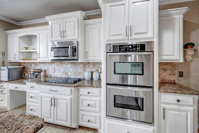 kitchen with backsplash, light stone countertops, stainless steel appliances, white cabinetry, and open shelves