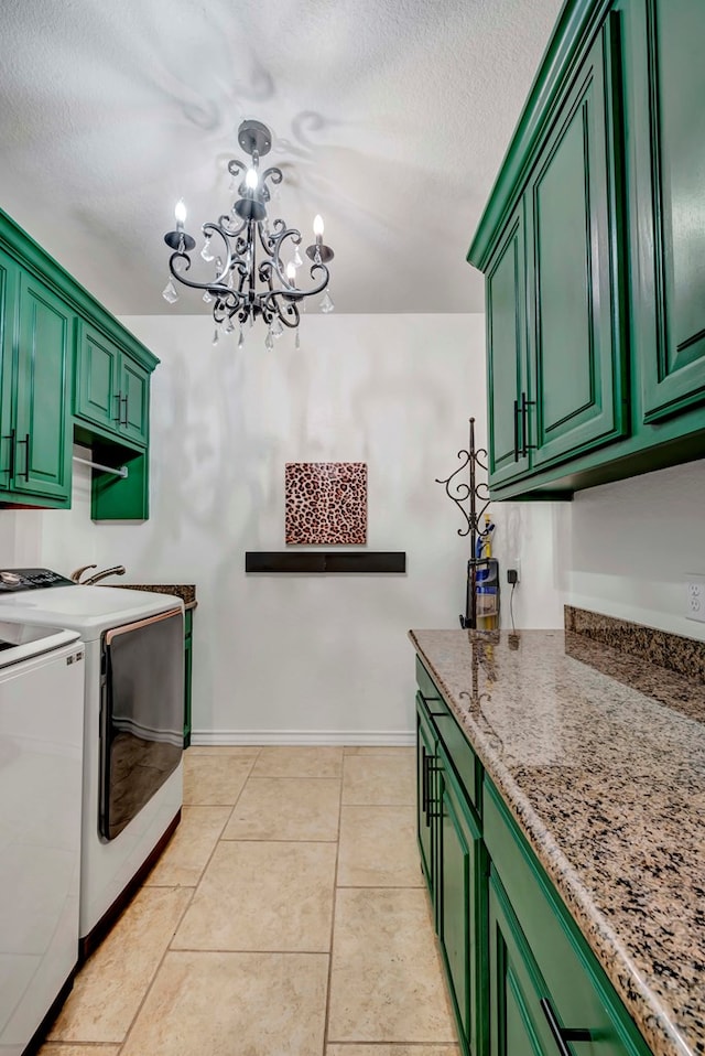 clothes washing area featuring washer and clothes dryer, a textured ceiling, cabinet space, light tile patterned floors, and baseboards