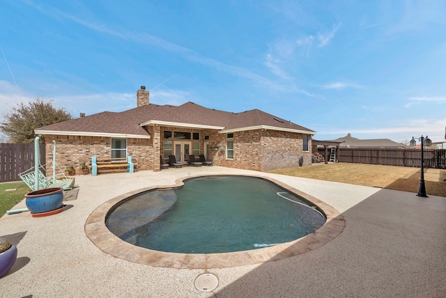 view of swimming pool with a patio area and a fenced backyard