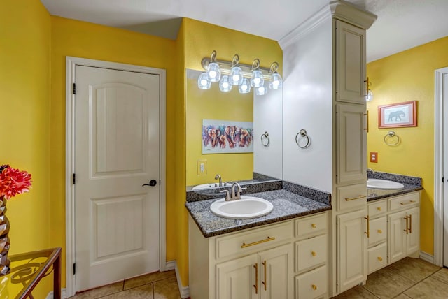 bathroom featuring tile patterned floors, two vanities, and a sink