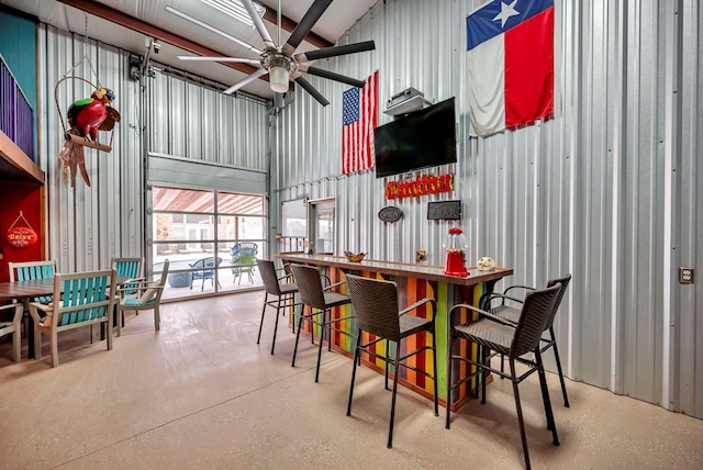 view of patio with outdoor dry bar and a ceiling fan