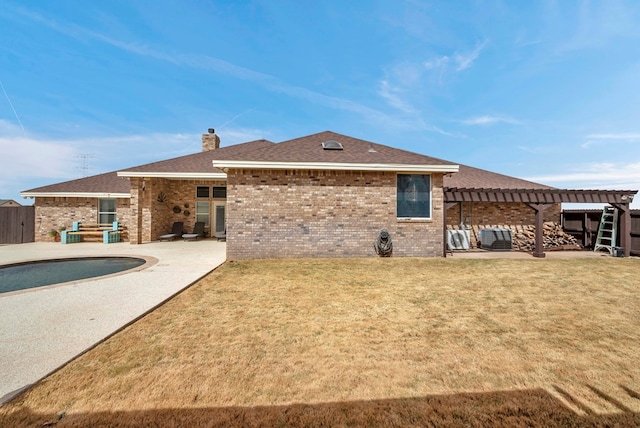 back of property with a patio area, a chimney, a pergola, and brick siding