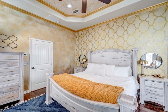 bedroom featuring visible vents, recessed lighting, ornamental molding, dark wood-type flooring, and a raised ceiling