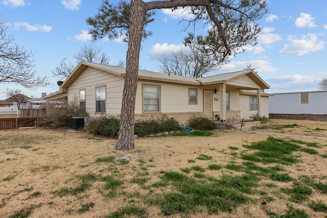 ranch-style house with a front lawn and cooling unit