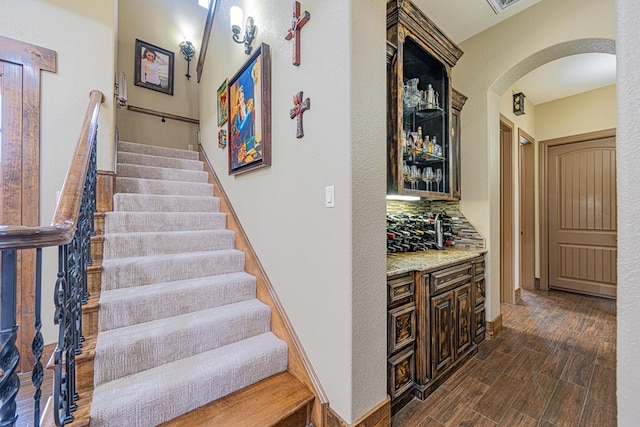 staircase with wood-type flooring