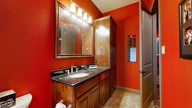 bathroom featuring tile patterned flooring, vanity, and toilet