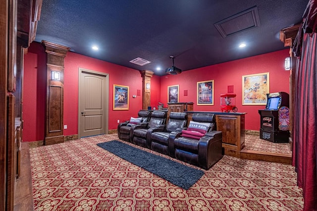 cinema featuring decorative columns and a textured ceiling