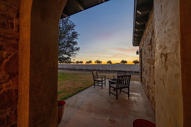 view of patio terrace at dusk