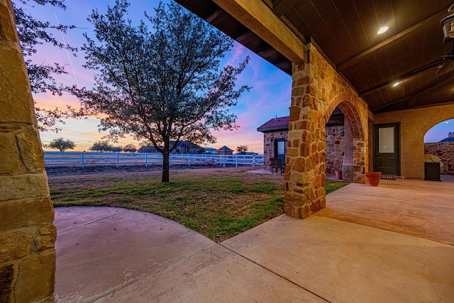 view of patio terrace at dusk