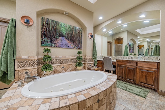 bathroom featuring vanity and shower with separate bathtub