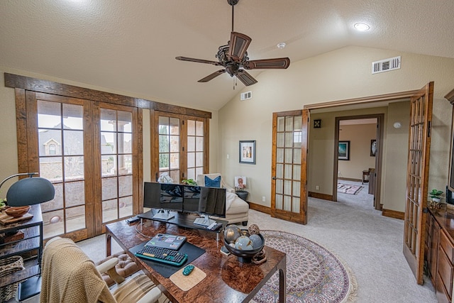 living room with french doors, vaulted ceiling, a textured ceiling, ceiling fan, and light colored carpet