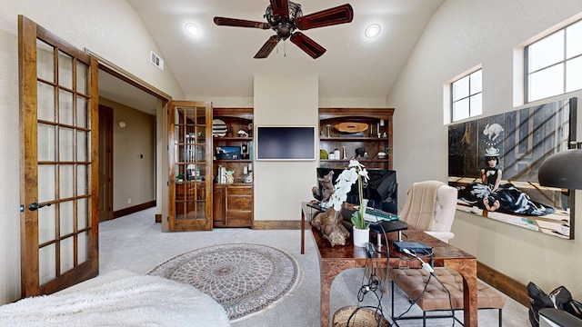 interior space featuring lofted ceiling, light colored carpet, french doors, and ceiling fan