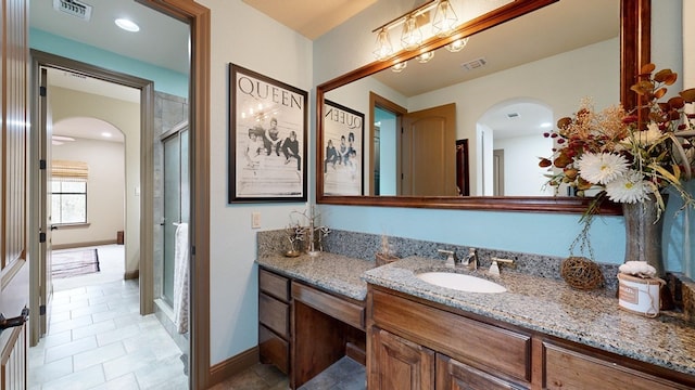 bathroom with vanity and walk in shower