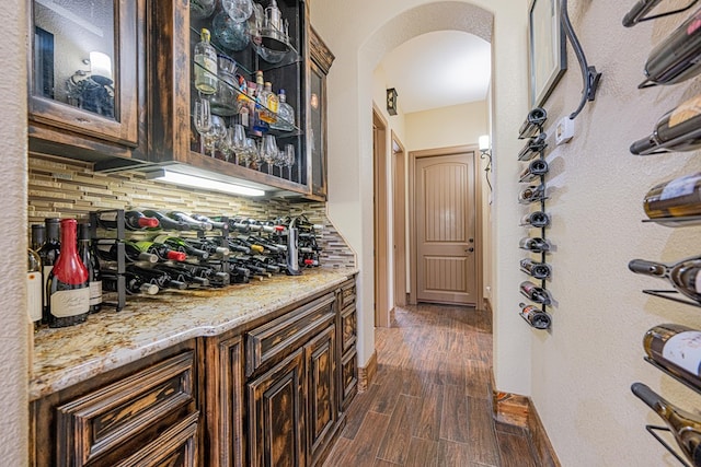 wine cellar featuring dark hardwood / wood-style floors and bar area