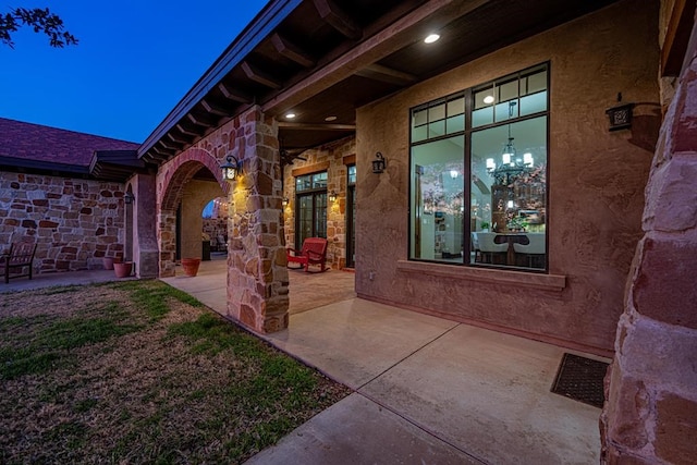 entrance to property featuring a patio area