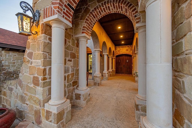 corridor featuring decorative columns