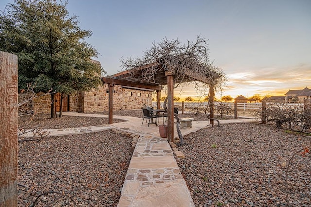 yard at dusk with a patio area