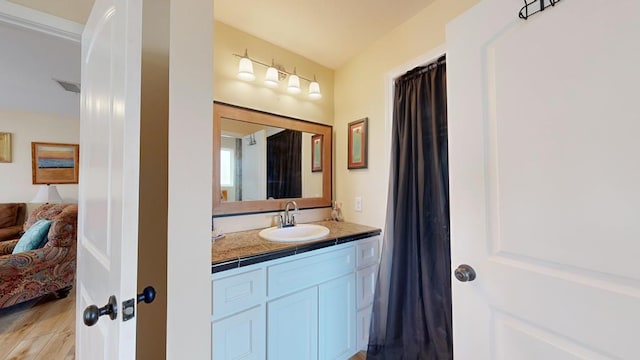 bathroom featuring hardwood / wood-style flooring and vanity