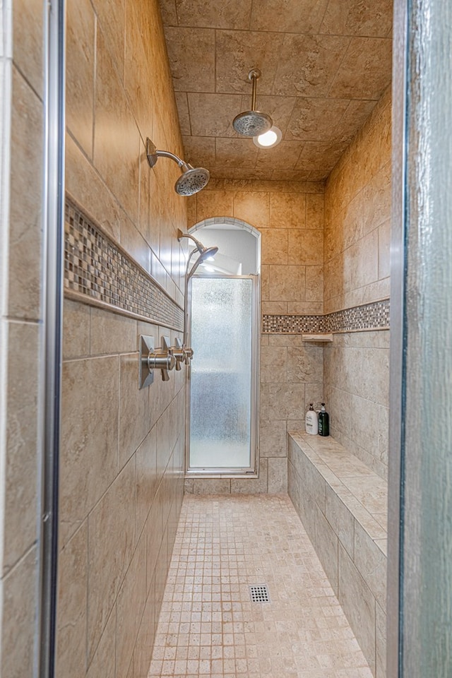 bathroom with a tile shower