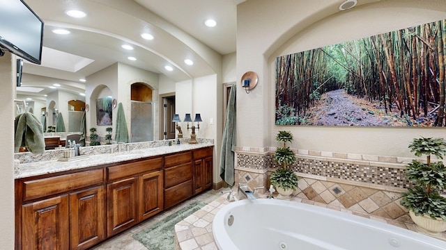 bathroom featuring vanity and separate shower and tub