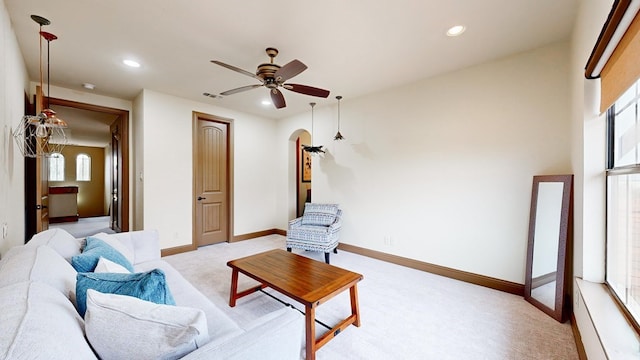 living room with light carpet and ceiling fan