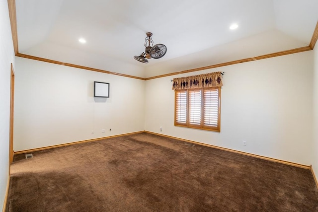 carpeted empty room featuring ornamental molding and a tray ceiling