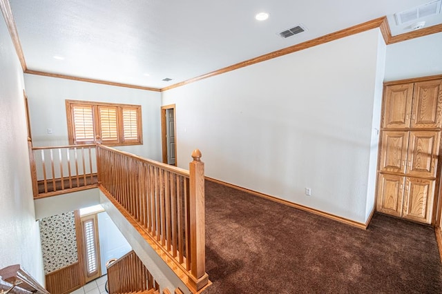 hall with carpet and ornamental molding