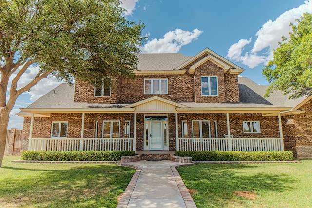 view of front facade featuring a front lawn and a porch