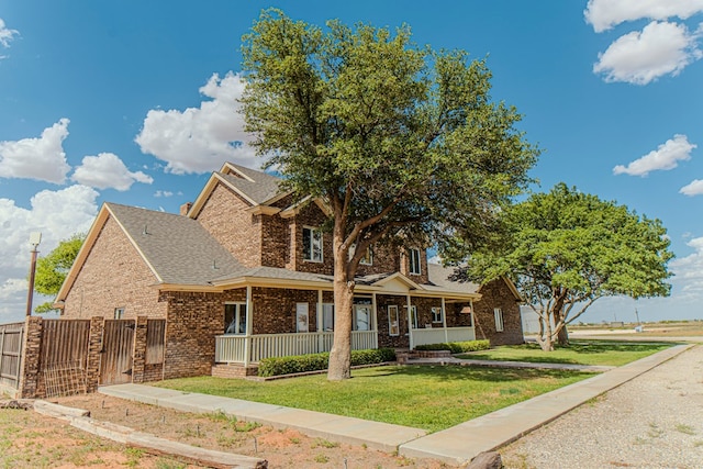 view of front facade with covered porch and a front lawn