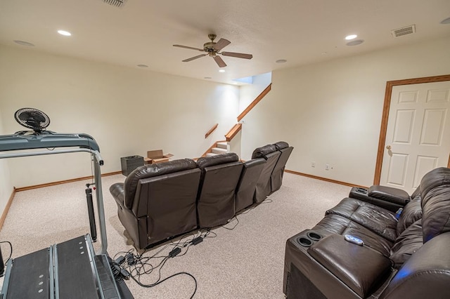 carpeted cinema room with ceiling fan