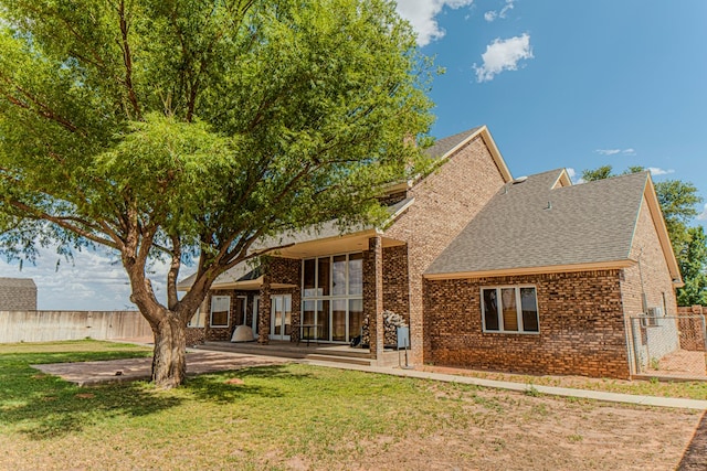 rear view of house with a patio area and a yard