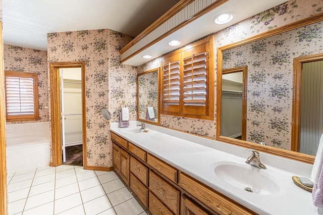 bathroom featuring vanity, a bathing tub, and tile patterned flooring