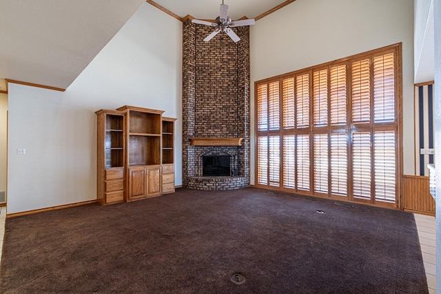 unfurnished living room featuring carpet flooring, crown molding, a brick fireplace, high vaulted ceiling, and ceiling fan